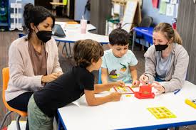 A teacher and children in a classroom