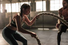 A woman using battle ropes.