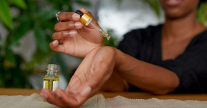 A woman put drops on her wrist